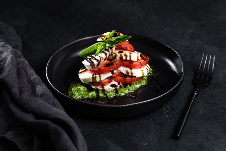 Caprese salad on black background